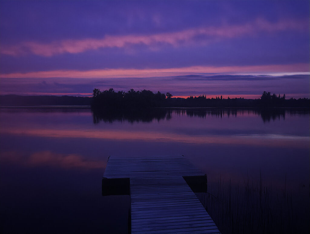 As the sun sets, the sky turns a brilliant cobalt blue colour with streams of fuchsia pink